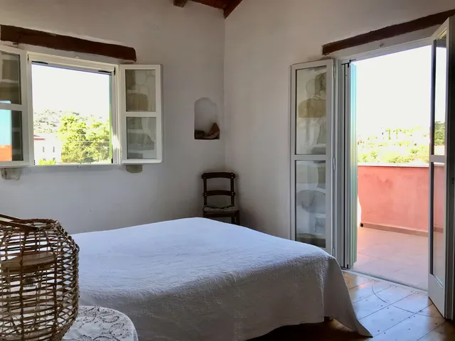 Hoofdslaapkamer met balkon en uitzicht op de tuin — Spiti Athinà, Gavalochori, Kreta